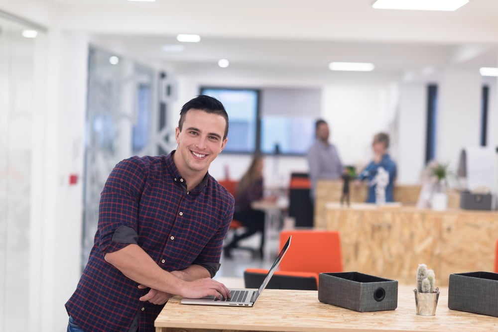 portrait of young businessman in casual clothes at modern  startup business office space,  working on laptop  computer